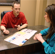 Dr. Travis Scott teaching a chiropractic patient about spinal health.